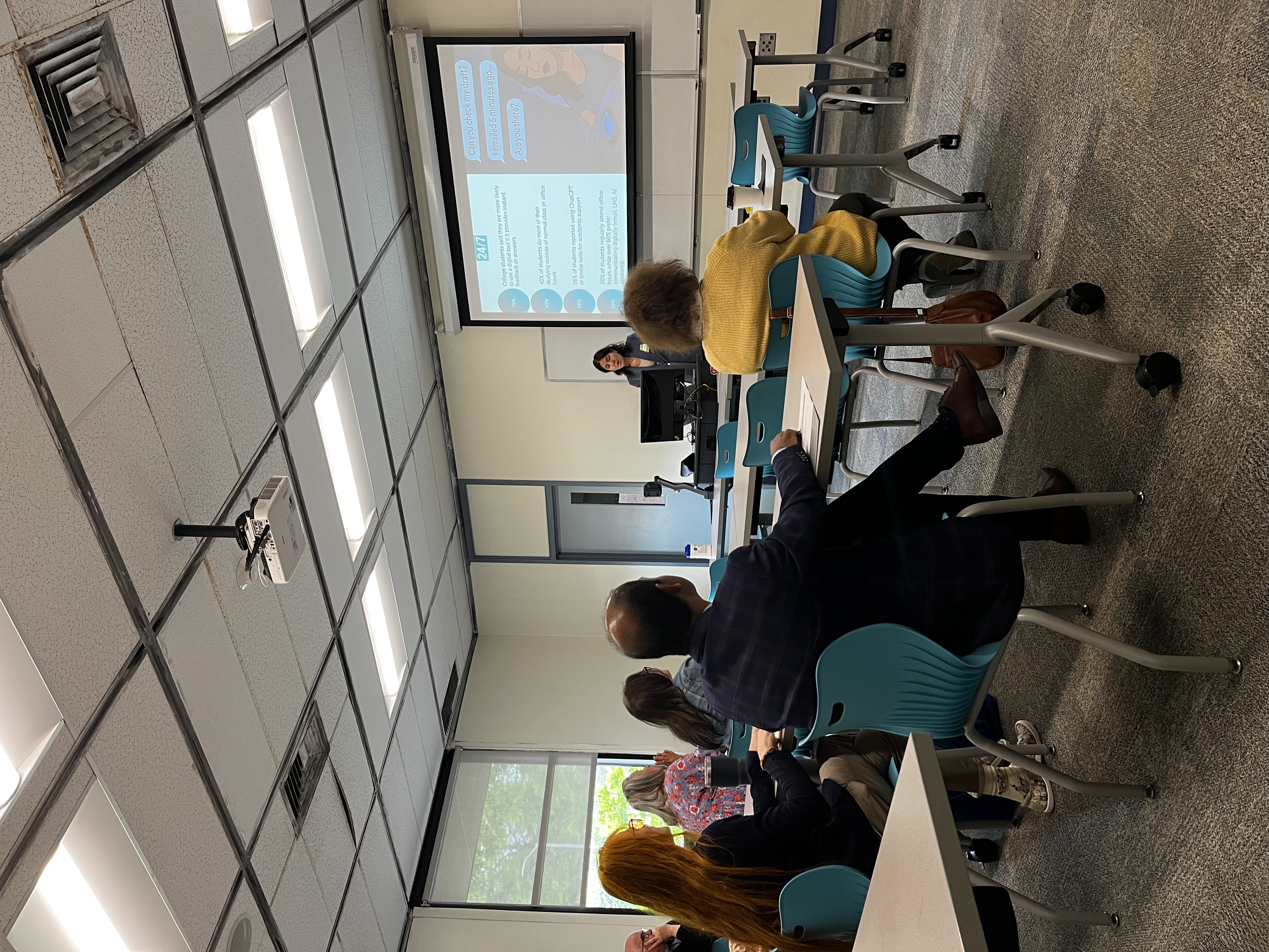 Dr. Gabriele presenting on stage to a large university audience